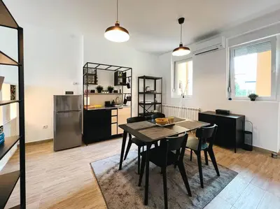 a kitchen and dining room with a table and chairs at Terrace Charm 25 in Belgrade