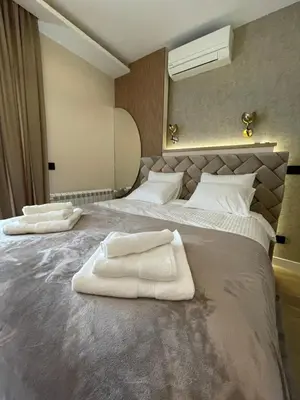 a bedroom with a large bed with white towels on it at BW Elena in Belgrade