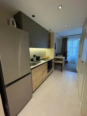 an empty kitchen with a refrigerator and a table at BW Elena in Belgrade