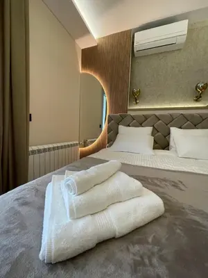 a hotel room with a bed with towels on it at BW Elena in Belgrade