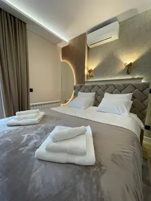 a bedroom with two beds with white towels on them at BW Elena in Belgrade