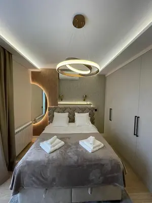 a bedroom with a large bed with two towels on it at BW Elena in Belgrade