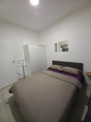 a bedroom with a large bed in a white room at Jans Belgrade in Belgrade