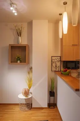 a kitchen with white walls and a counter and a table at Yellow Lux apartment in Novi Beograd