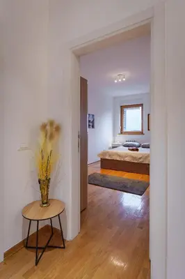 a bedroom with a bed and a table in a room at Yellow Lux apartment in Novi Beograd