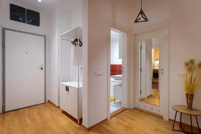 a white room with a door and a hallway at Yellow Lux apartment in Novi Beograd