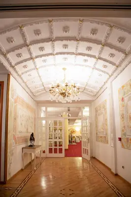 a large room with a ceiling with a chandelier at Hotel Radmilovac in Belgrade