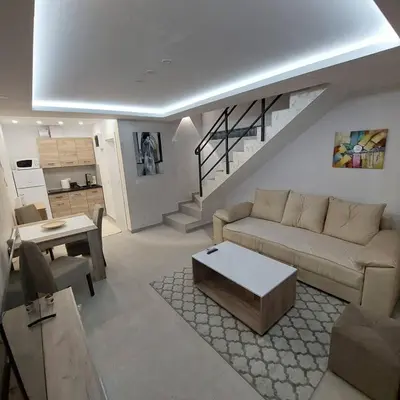 a living room with a couch and a table at Apartman LUX Jelena in Surčin