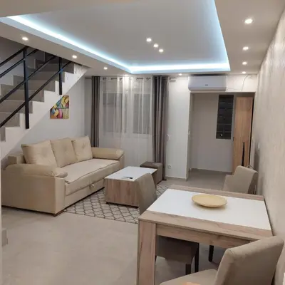a living room with a couch and a table at Apartman LUX Jelena in Surčin