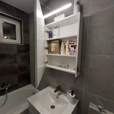 a bathroom with a sink and a toilet and a tub at Apartman LUX Jelena in Surčin