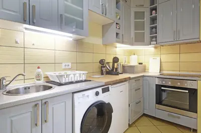 a kitchen with a washing machine and a sink at Relax Home Downtown Apartment in Belgrade