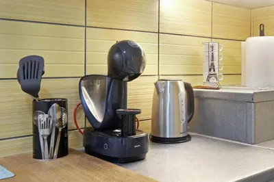 a kitchen counter with a blender and utensils at Relax Home Downtown Apartment in Belgrade