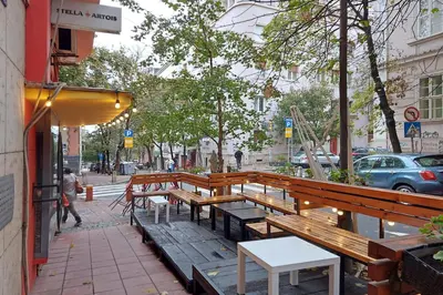 a row of wooden benches on a city street at Relax Home Downtown Apartment in Belgrade