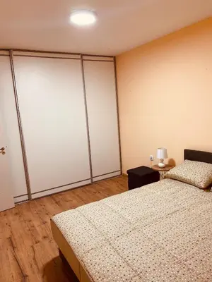 a bedroom with white sliding doors and a bed at Aleksa in Novi Grad