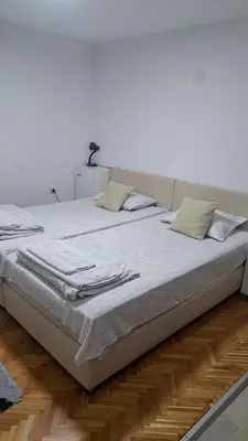 a large bed with white sheets and napkins on it at Apartment Gajic in Belgrade