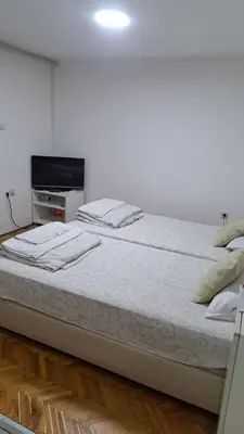 a large bed in a room with a television at Apartment Gajic in Belgrade