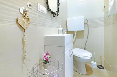 a small bathroom with a toilet and a sink at Apartment Paradise Nice Home in Belgrade
