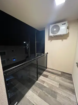 a room with a television and a air conditioner on a wall at STAN NA DAN MILA in Irig