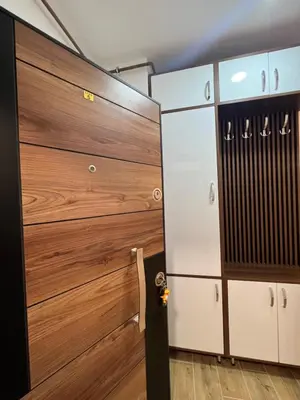 a locker room with wooden doors and cabinets at STAN NA DAN MILA in Irig