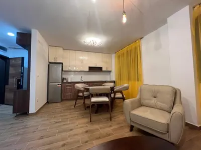 a kitchen and living room with a table and chairs at STAN NA DAN MILA in Irig