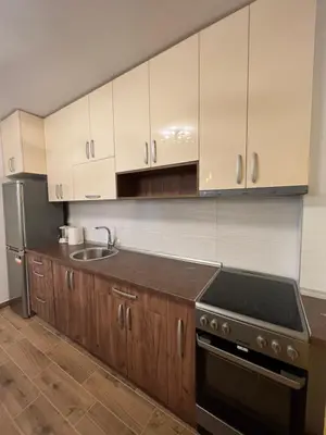 a kitchen with white cabinets and a stove top oven at STAN NA DAN MILA in Irig