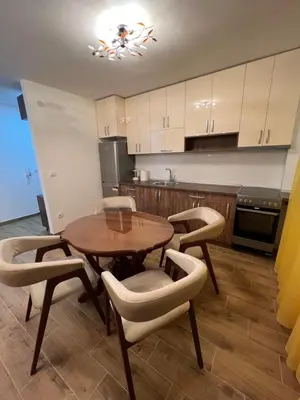 a kitchen with a wooden table and chairs and a table at STAN NA DAN MILA in Irig