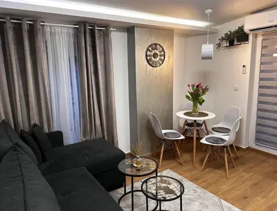 a living room with a couch and a table at Apartman Savamala Promenada 57 in Belgrade