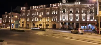 a lit up building on a city street at night at Apartman Savamala Promenada 57 in Belgrade