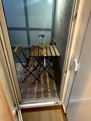 a small table with a vase on it in a hallway at Apartman Savamala Promenada 57 in Belgrade