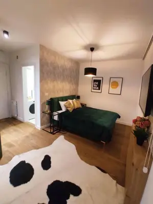 a bedroom with a bed with a green blanket at Aria in Belgrade