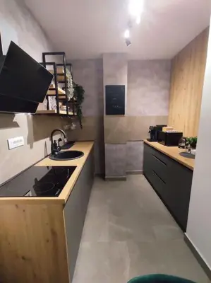 a small kitchen with a sink and a stove at Aria in Belgrade