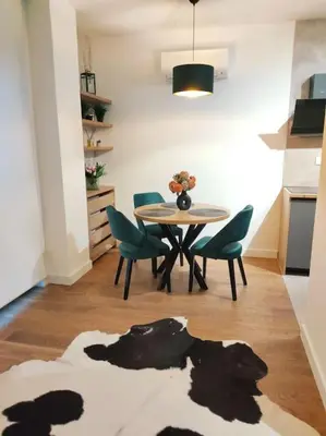 a dining room with a table and chairs and a kitchen at Aria in Belgrade