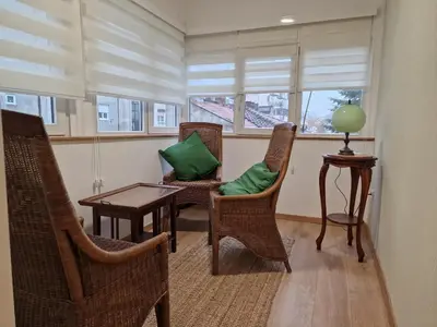 a living room with chairs and a table and a window at Apartment Olga in Vračar (historical)