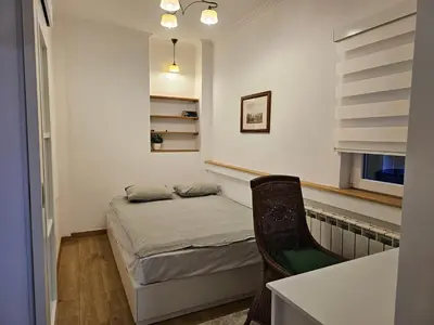 a small bedroom with a small bed and a chair at Apartment Olga in Vračar (historical)