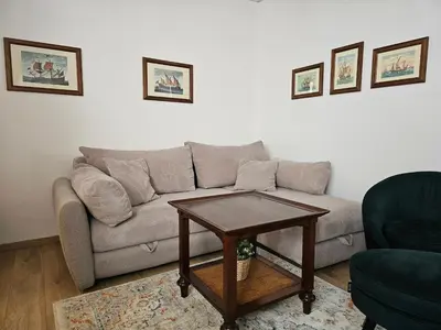 a living room with a couch and a coffee table at Apartment Olga in Vračar (historical)