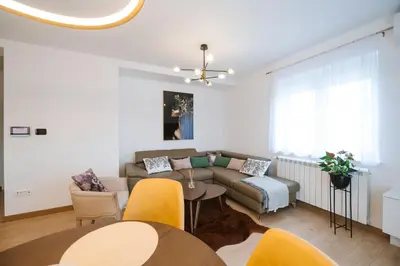 a living room with a couch and a table at Nika apartman in Surčin