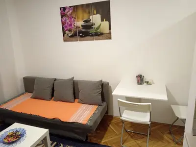 a living room with a couch and a table at Apartman Mirka 1 in Karaburma
