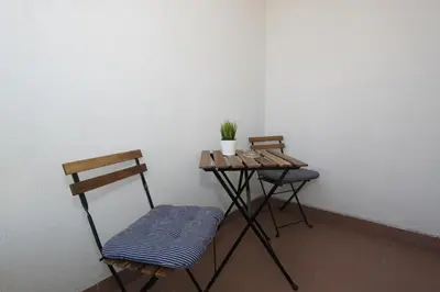 a small table and two chairs in a room at Evergreen - studio in Belgrade to relax and enjoy, parking 5 eur per day in Belgrade