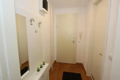a white hallway with a white door and a mirror at Evergreen - studio in Belgrade to relax and enjoy, parking 5 eur per day in Belgrade