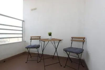 a table and two chairs in a room with a window at Evergreen - studio in Belgrade to relax and enjoy, parking 5 eur per day in Belgrade