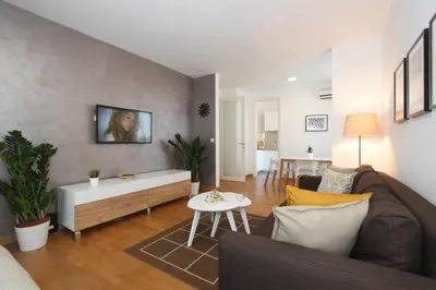 a living room with a couch and a table at Evergreen - studio in Belgrade to relax and enjoy, parking 5 eur per day in Belgrade