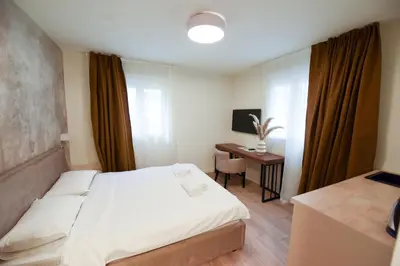 a hotel room with a bed and a desk at HOTEL Iva Old Town in Belgrade