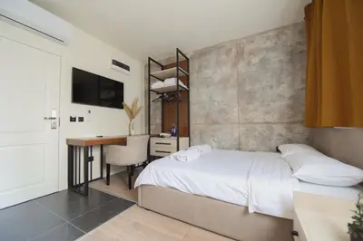 a bedroom with a bed and a desk with a computer at HOTEL Iva Old Town in Belgrade