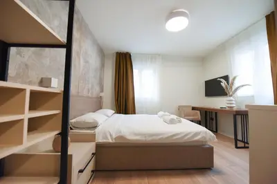 a bedroom with a bed and a desk in it at HOTEL Iva Old Town in Belgrade