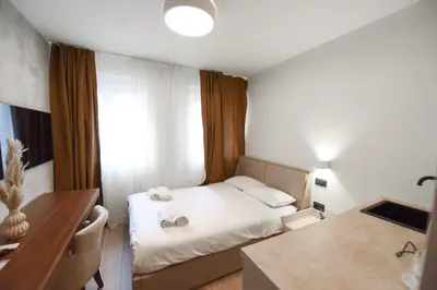 a small room with a bed and a desk at HOTEL Iva Old Town in Belgrade