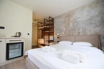 a bedroom with two beds with white towels on them at HOTEL Iva Old Town in Belgrade