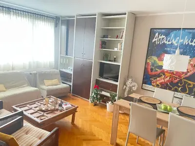 a living room with a couch and a table at Apartman 23 in Kanarevo Brdo