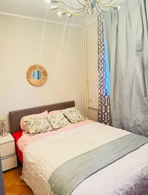 a bedroom with a bed and a mirror at Apartman 23 in Kanarevo Brdo