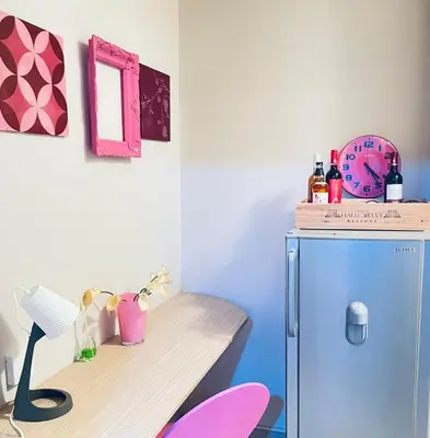 a room with a desk and a small refrigerator at Apartman 23 in Kanarevo Brdo