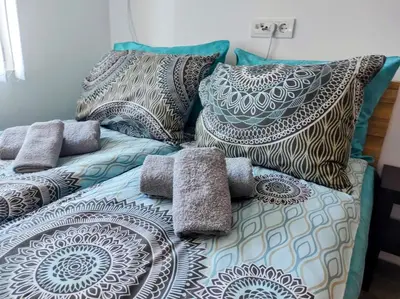 a bed with pillows on top of it at Le Petit Studio in Kanarevo Brdo
